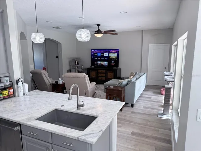 a living room with furniture a fireplace and flat screen tv