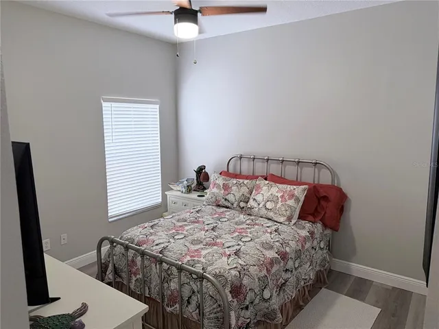 a bed sitting in a bedroom next to a window