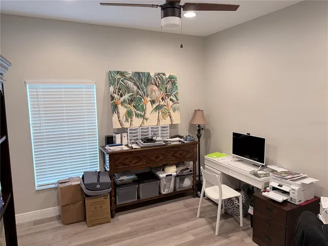 a view of a workspace with furniture and a window