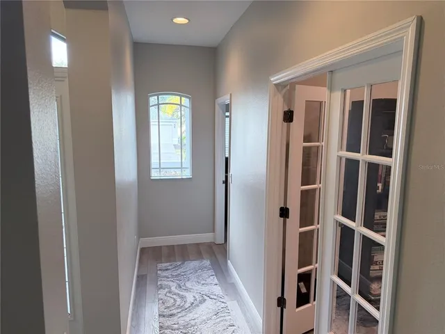 a view of an entryway with wooden floor