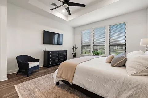 a bedroom with a bed a chair and a fireplace