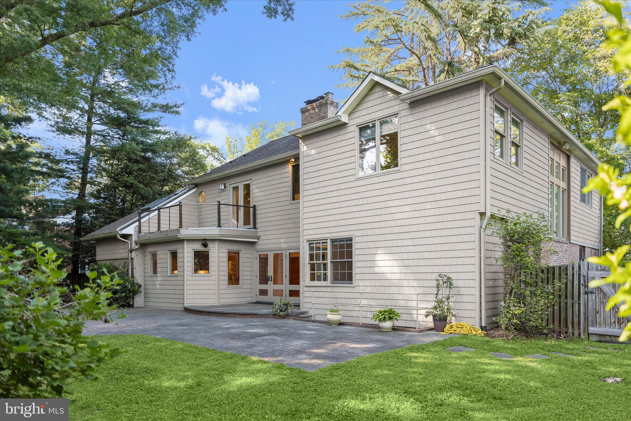 5104 Scarsdale Road Bethesda, MD 20816 - Photo 65 of 68 a front view of a house with a yard and outdoor seating
