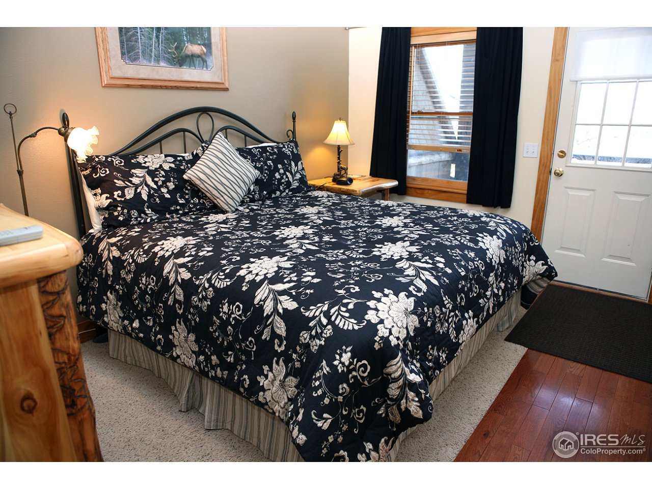 2625 Marys Lake Road, Unit 101 Estes Park, CO 80517 - Photo 12 of 25 a bed sitting in a bedroom next to a window