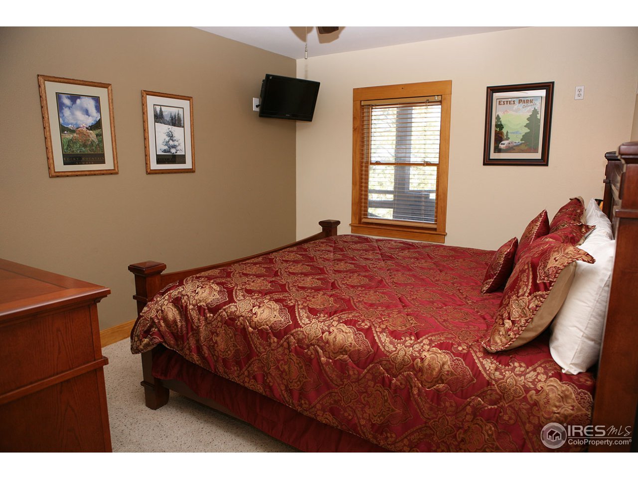 2625 Marys Lake Road, Unit 101 Estes Park, CO 80517 - Photo 15 of 25 a bed sitting in a bedroom next to a window