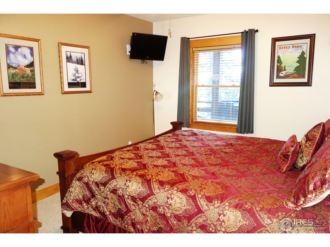 2625 Marys Lake Road, Unit 101 Estes Park, CO 80517 - Photo 7 of 25 a bed sitting in a bedroom next to a window