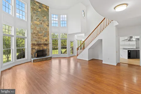 a kitchen with a stove a sink a center island and windows