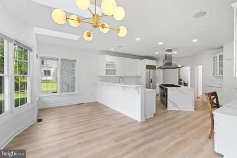 a kitchen with granite countertop a stove and a wooden floors