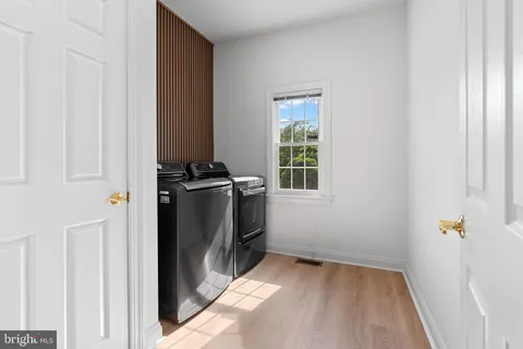 an empty room with fireplace and window