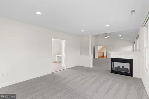 an empty room with windows and closet