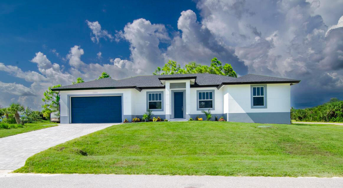 10654 Washington Road Port Charlotte, FL 33981 - Photo 2 of 36 front view of a house with a yard