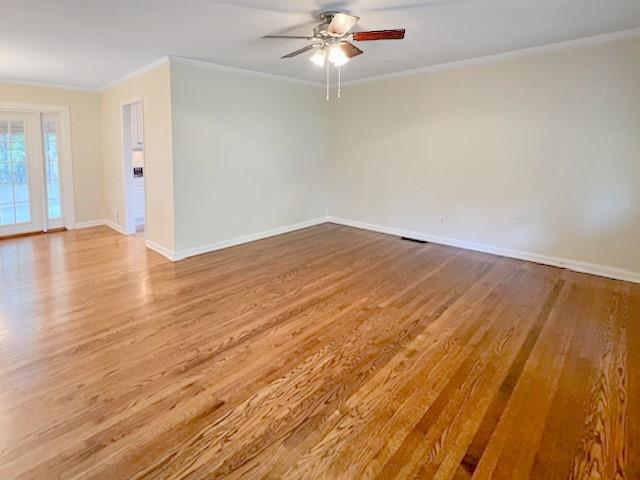 2711 Fairlane Drive Atlanta, GA 30340 - Photo 7 of 31 wooden floor in an empty room with a chandelier fan
