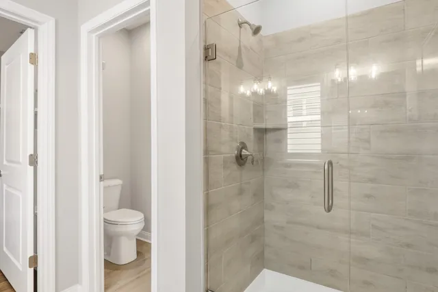 a bathroom with a shower and a toilet