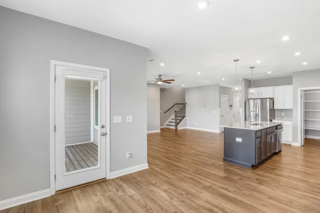 a view of kitchen and hall with wooden floor