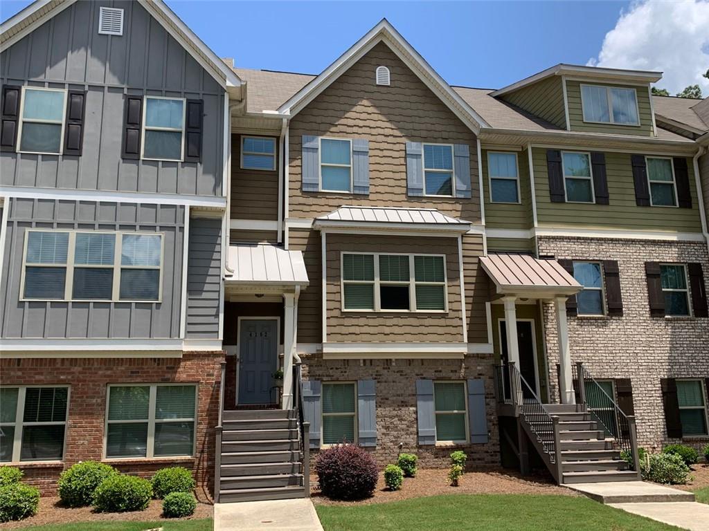 4162 Integrity Way Powder Springs, GA 30127 - Photo 1 of 1 a front view of a residential apartment building with a yard