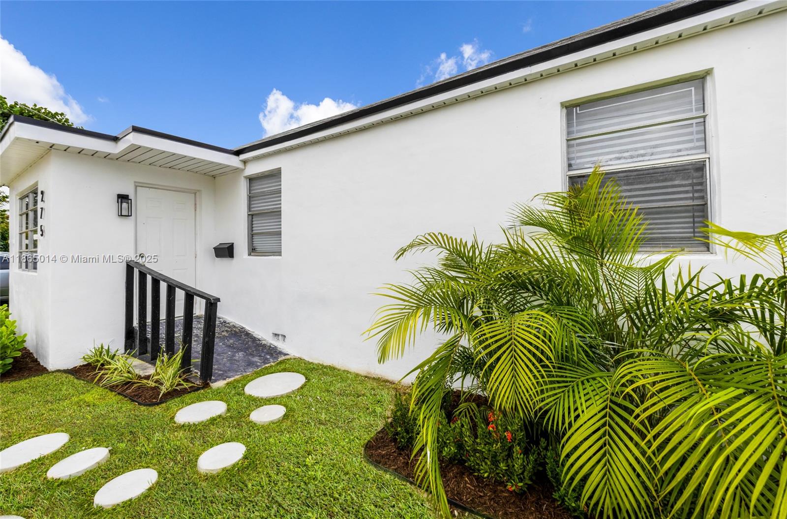 a view of an house with backyard and patio