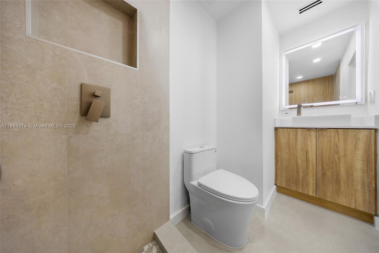 275 Northwest 97th Street Miami, FL 33150 - Photo 13 of 26 a white toilet sitting next to a bathroom sink