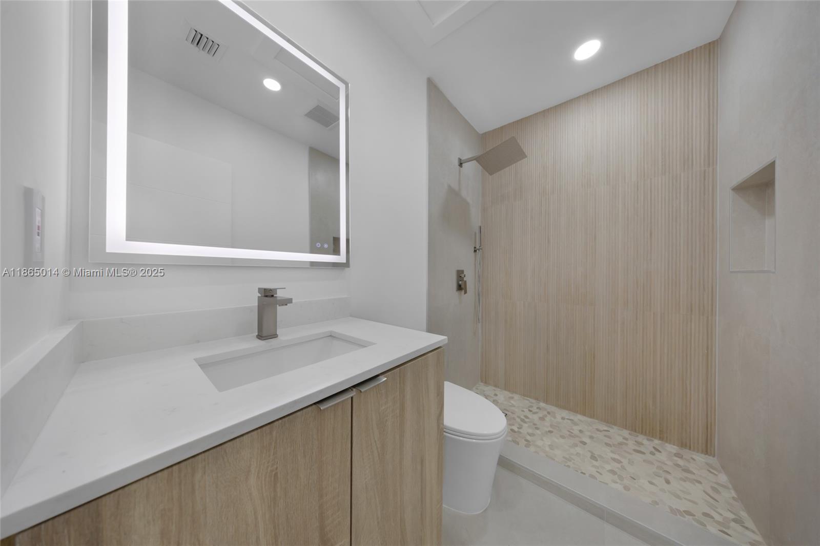 275 Northwest 97th Street Miami, FL 33150 - Photo 17 of 26 a bathroom with a sink a toilet and a mirror