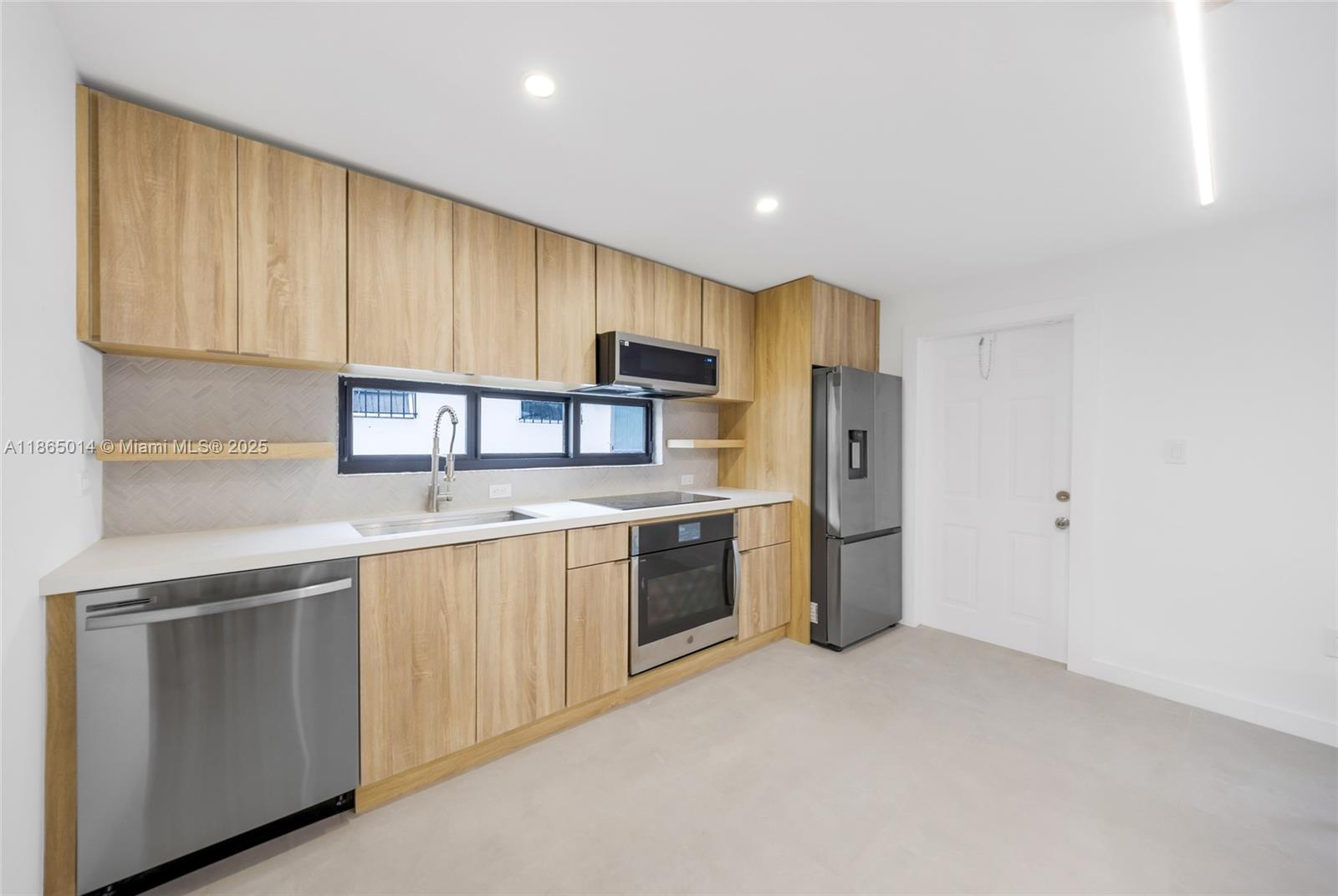 275 Northwest 97th Street Miami, FL 33150 - Photo 4 of 26 a kitchen with a sink cabinets stainless steel appliances and a window