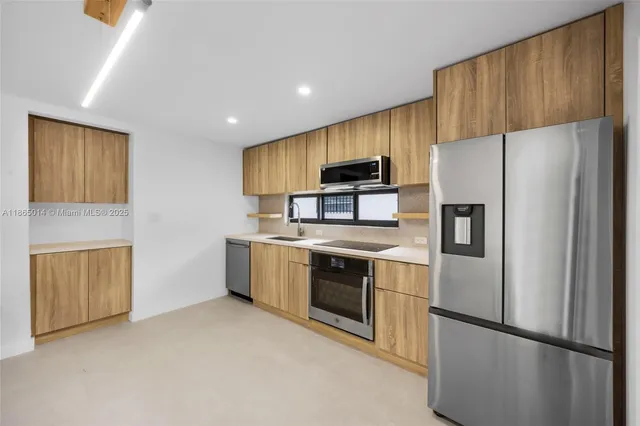 a kitchen with stainless steel appliances a refrigerator stove and sink