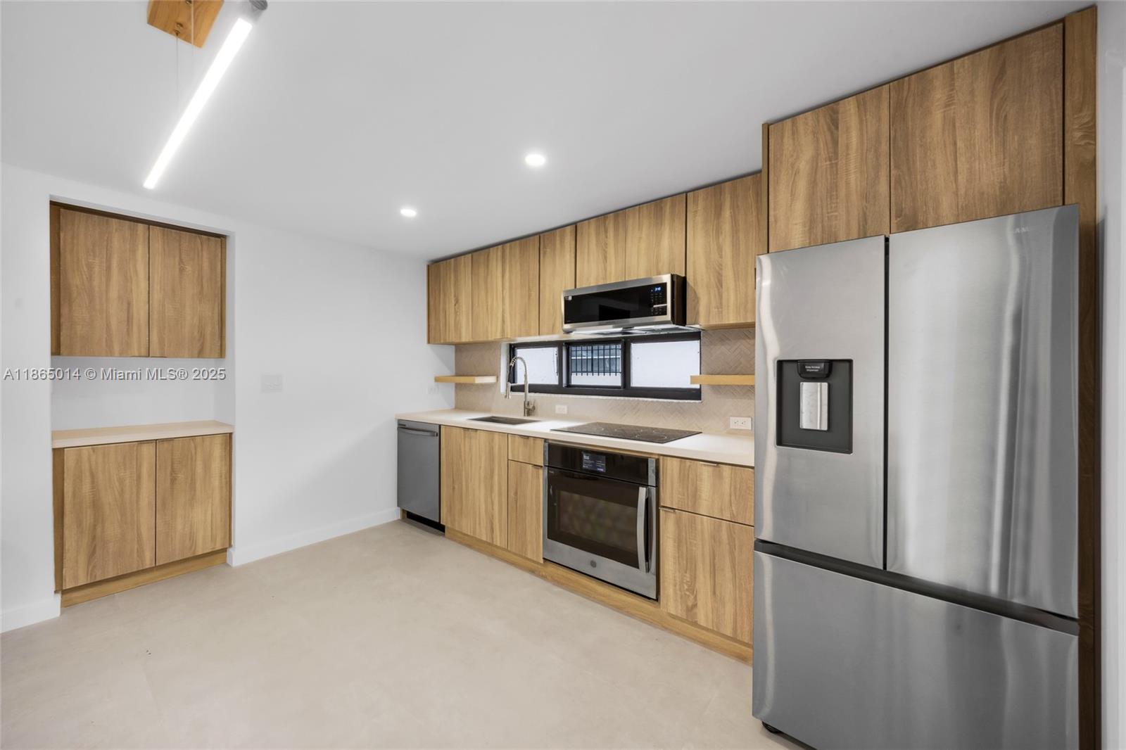 275 Northwest 97th Street Miami, FL 33150 - Photo 6 of 26 a kitchen with stainless steel appliances a refrigerator stove and sink