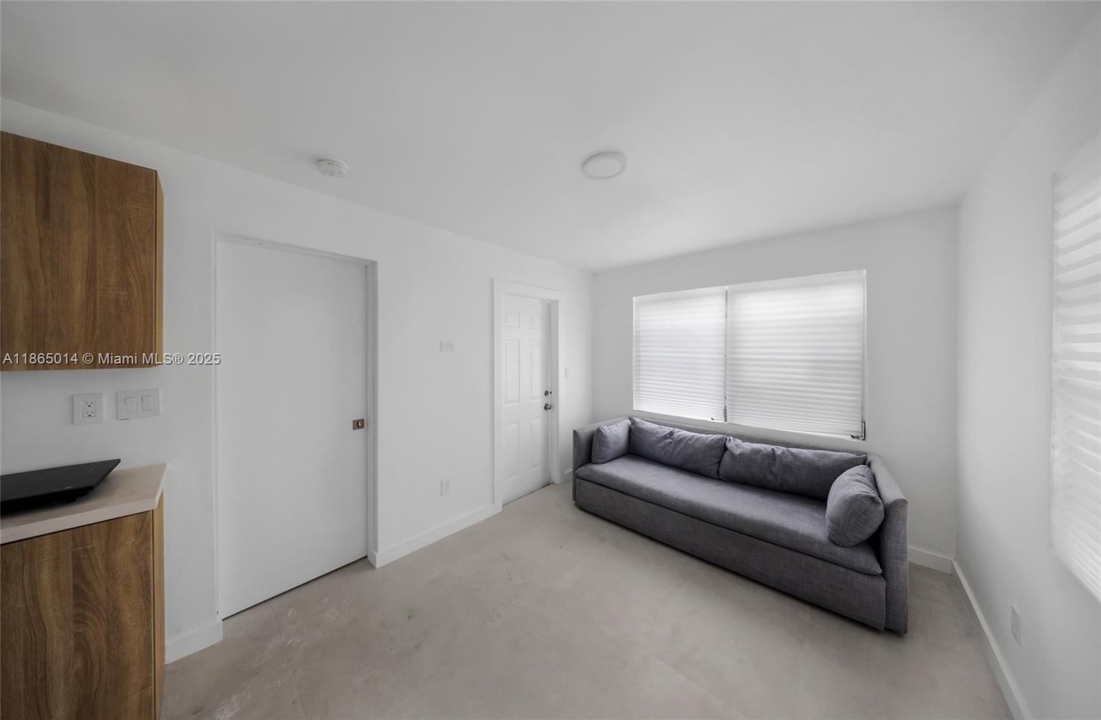 275 Northwest 97th Street Miami, FL 33150 - Photo 10 of 26 a living room with a couch and a flat screen tv