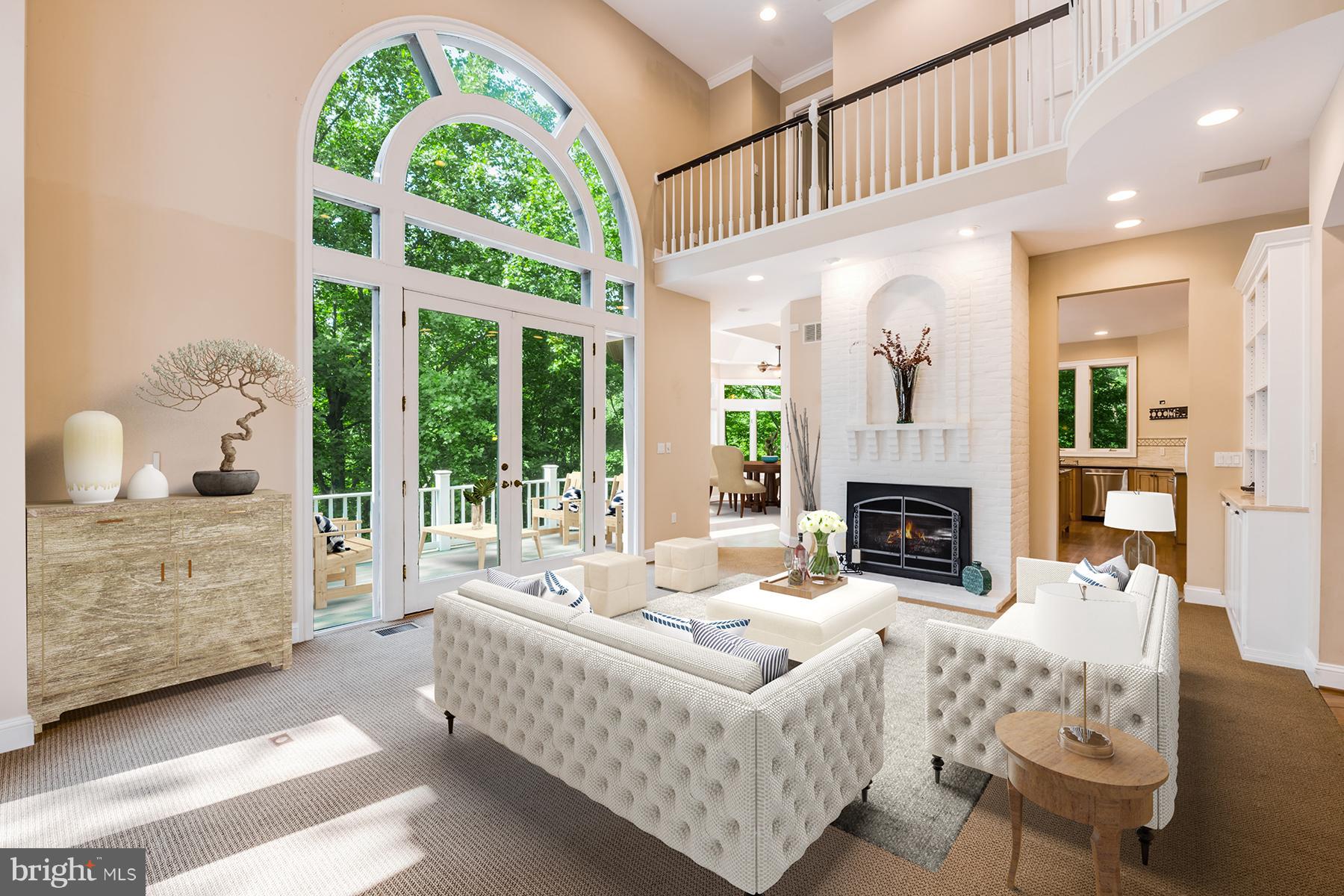 1202 Marinaview Drive Arnold, MD 21012 - Photo 6 of 26 a living room with furniture a fireplace and a floor to ceiling window