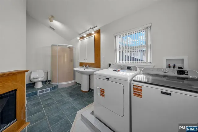 a spacious bathroom with a toilet sink and mirror