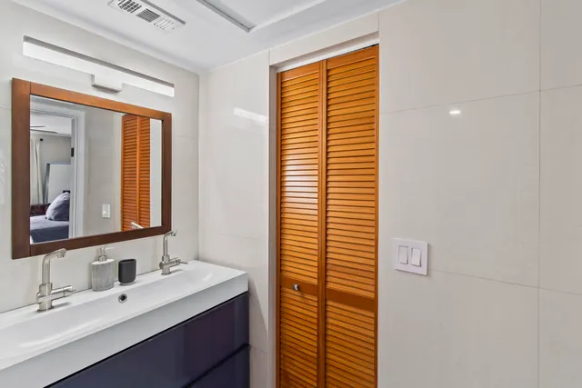 a bathroom with a sink a vanity and a mirror