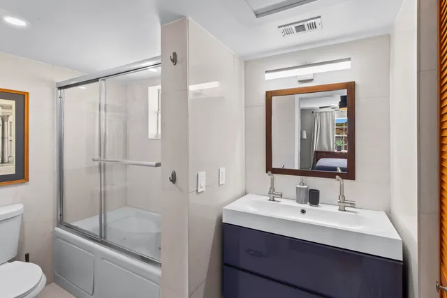 a bathroom with a toilet a sink and shower