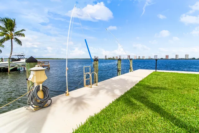 a view of a chairs and table in patio with swimming pool