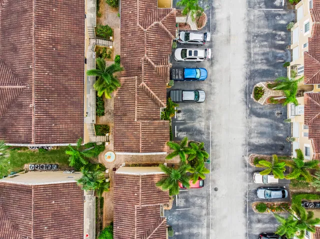 a front view of a house with a yard and potted plants