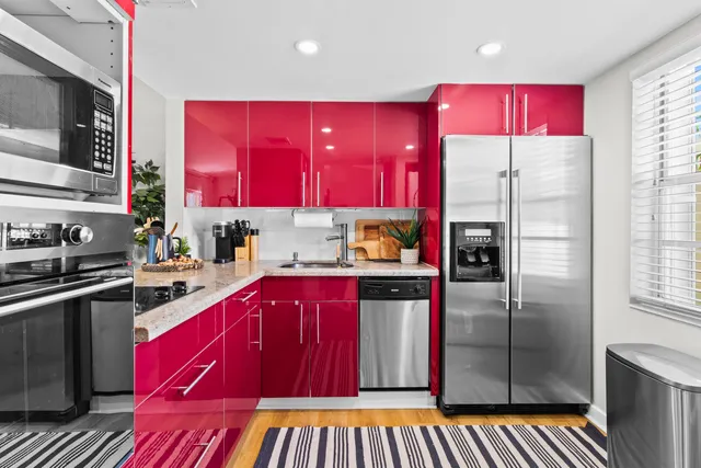 a kitchen with stainless steel appliances kitchen island granite countertop a refrigerator and a stove