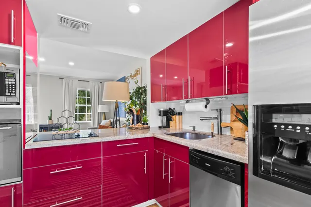 a kitchen with red cabinets and sink