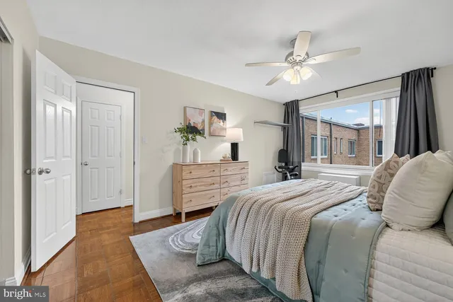 a bedroom with a large bed and a chandelier