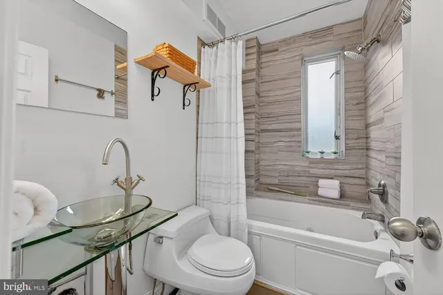 a bathroom with a sink a toilet and a bathtub