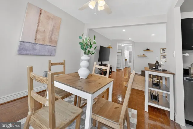 a view of a dining room with furniture and wooden floor