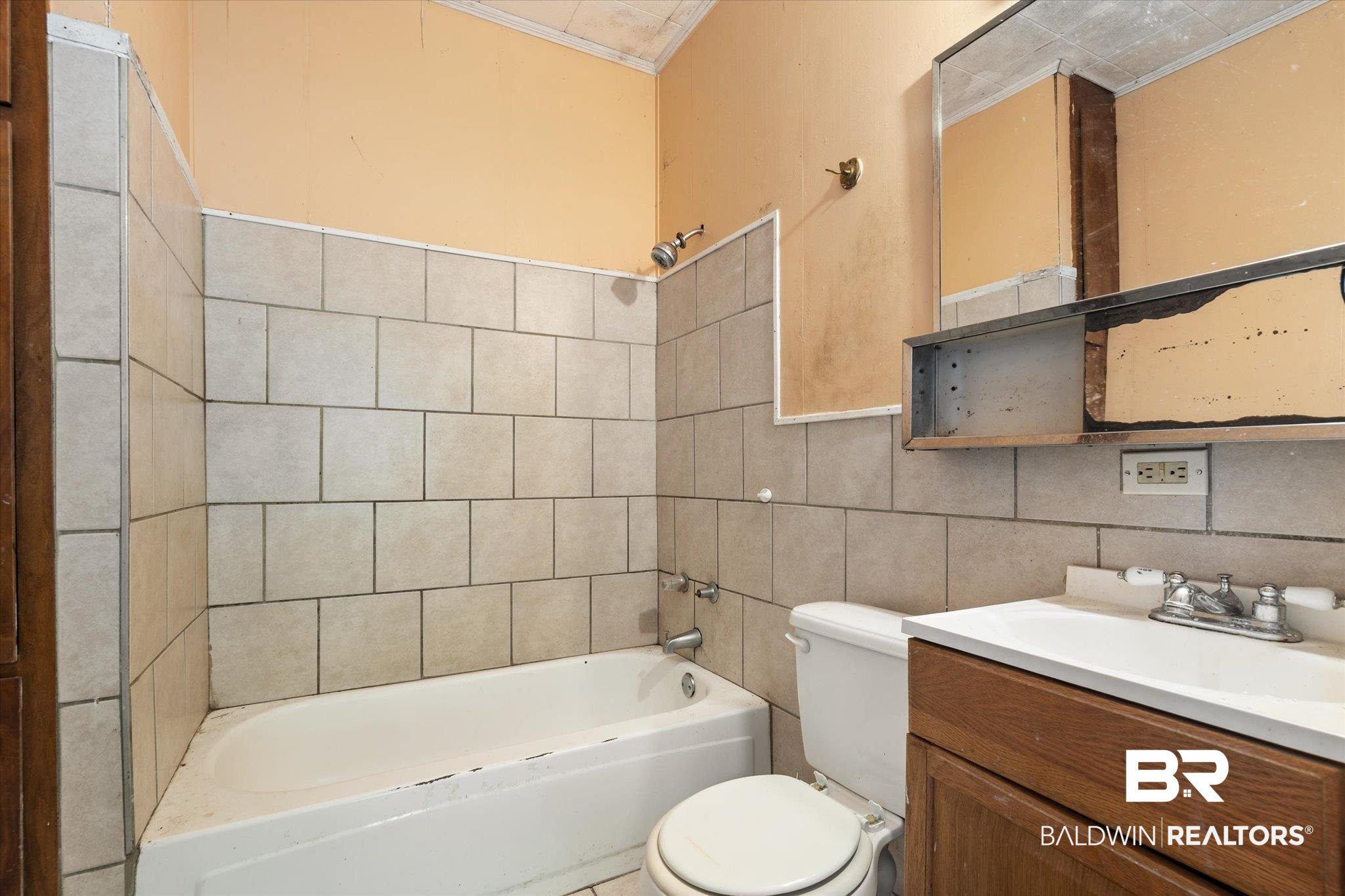 672 Burden Street Mobile, AL 36607 - Photo 14 of 20 Full bathroom with toilet, tile walls, vanity, bathtub / shower combination, and crown molding