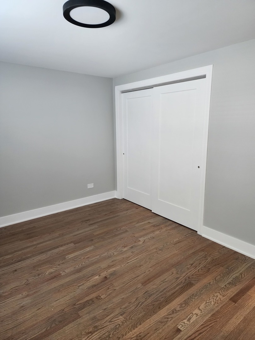 9421 South Roberts Road, Unit 1NW Hickory Hills, IL 60457 - Photo 7 of 12 a view of a room with wooden floor and a sink