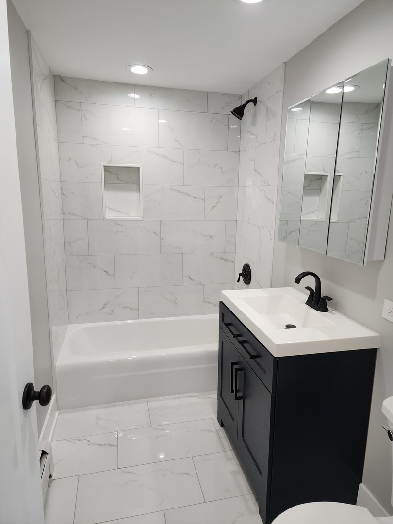 9421 South Roberts Road, Unit 1NW Hickory Hills, IL 60457 - Photo 9 of 12 a bathroom with a sink a toilet and shower