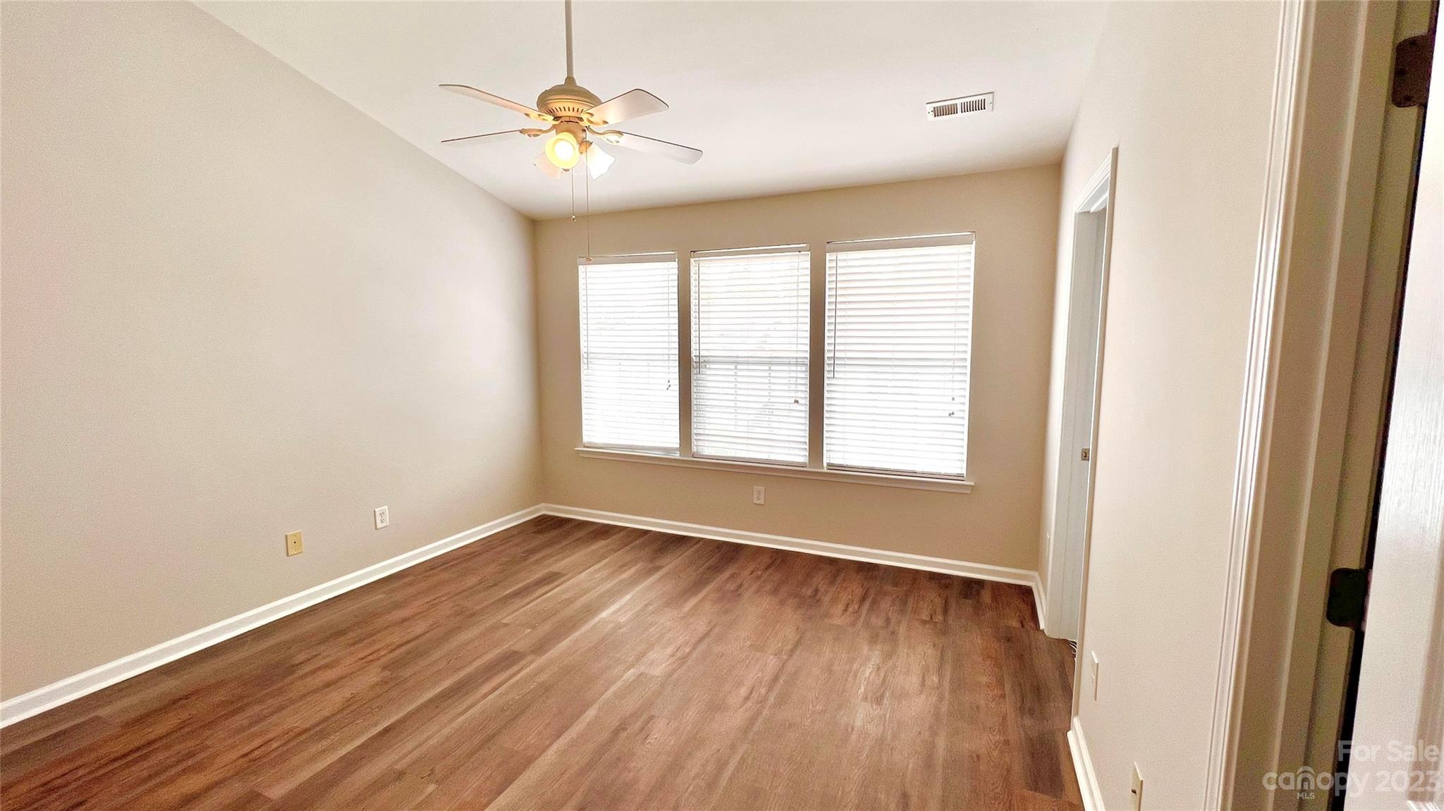 637 Brickdust Court Fort Mill, SC 29708 - Photo 12 of 18 wooden floor in an empty room with a window