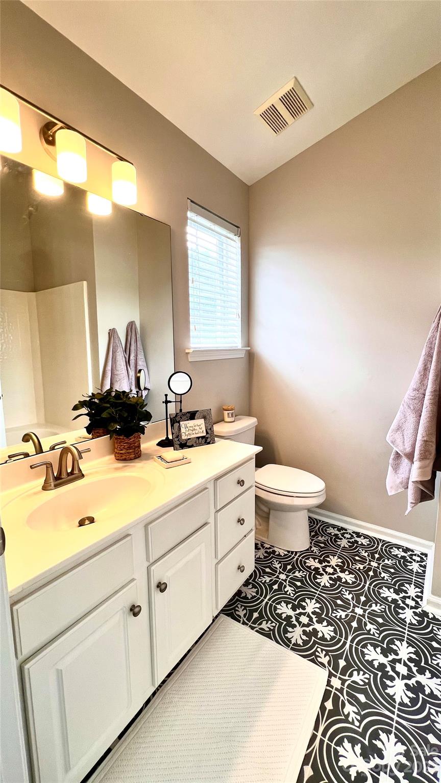 637 Brickdust Court Fort Mill, SC 29708 - Photo 14 of 18 a bathroom with a double vanity sink toilet and a mirror