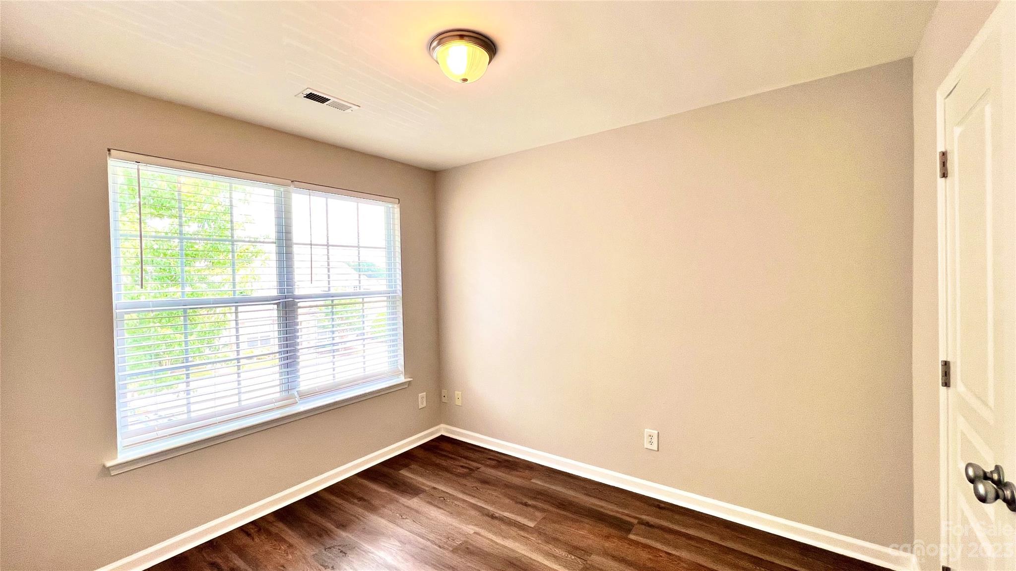 637 Brickdust Court Fort Mill, SC 29708 - Photo 16 of 18 a view of an empty room with wooden floor and a window