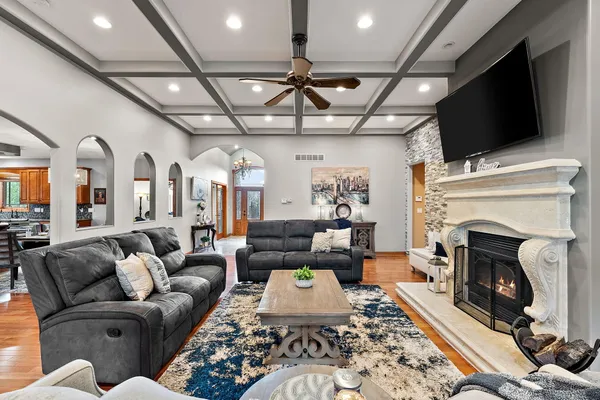a living room with furniture a fireplace and a flat screen tv