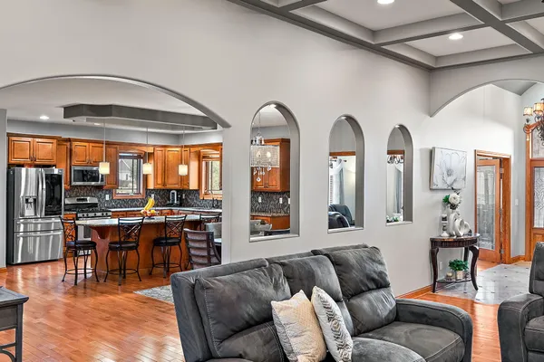 a living room with furniture a fireplace and a large window