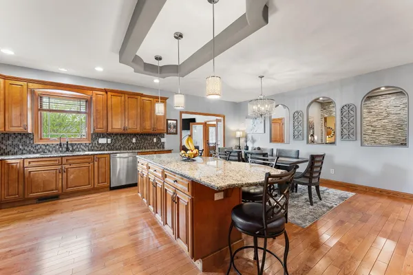 a large kitchen with a table and chairs