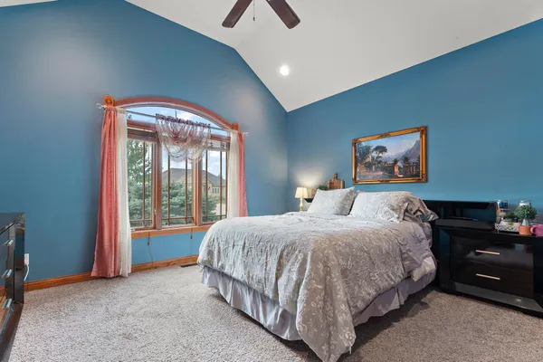 a bedroom with a bed and a chandelier