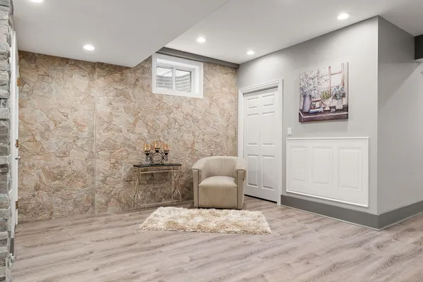 a room with furniture pool table and wooden floor
