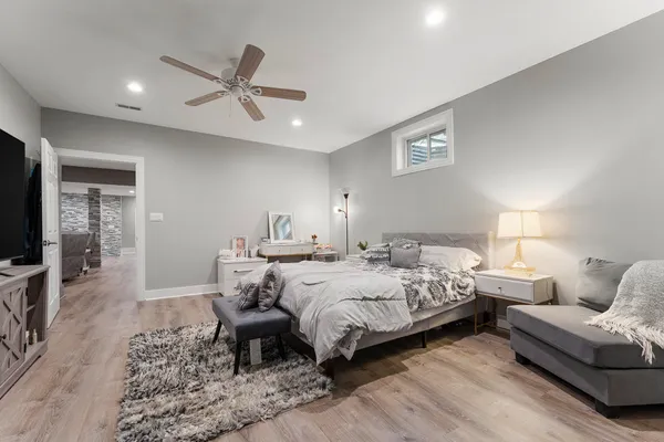 a bath room with a toilet a sink and a mirror