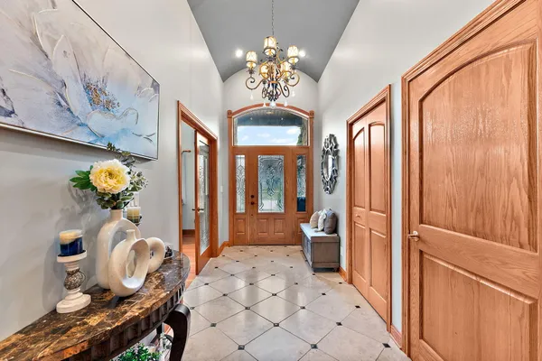 a dining room with furniture and chandelier