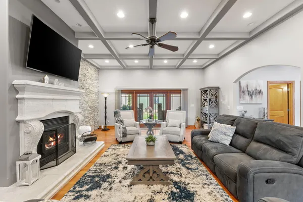 a living room with fireplace furniture and a flat screen tv